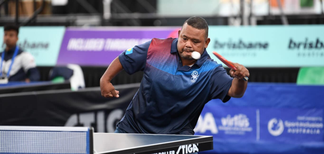 Male table tennis player from the Republic of Palau hitting table tennis ball in competition