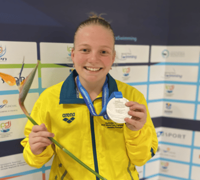 Ruby Storm at the 2022 World Para Swimming Championships holding up her silver medal
